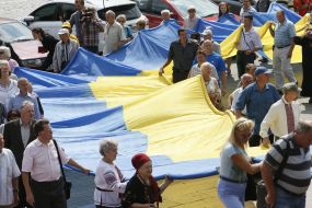 The participants of action hold the enormous flag of Ukraine