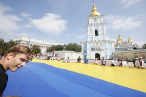 The participants of action hold the enormous flag of Ukraine