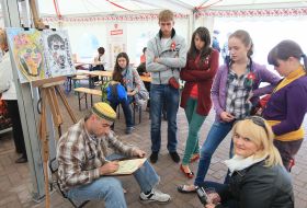 An artist draws the portrait of girl 