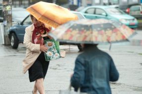 Passers-by with an umbrella