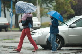 Passers-by with an umbrella