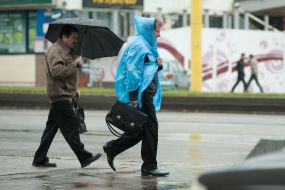 Passers-by with an umbrella