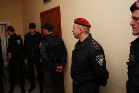 Militiamen outside the courtroom