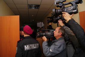Militiamen outside the courtroom