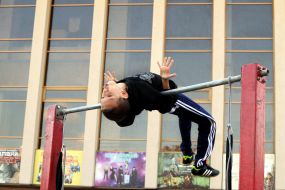 Young man doing exercises on the horizontal bar