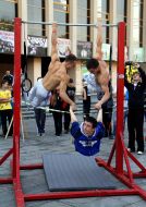 Men doing exercises on the horizontal bar