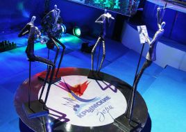 Statuettes of bandleader and musicians near an emblem