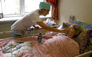Nurse giving medicine patient hospice