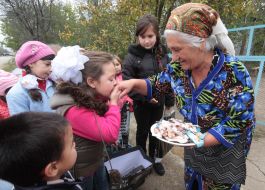 The girl kisses the hand of an elderly woman