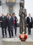 Sculpture of girl with ears in hands