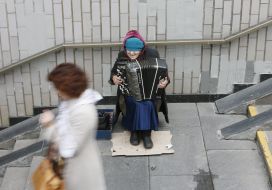 The woman plays an accordion