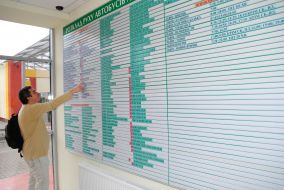 A man looks bus schedules