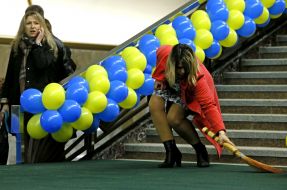 The girl sweeps a floor