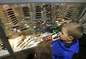 Boys looking at knives