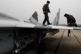 The technician in the cockpit of the MiG-29