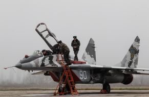 The technician in the cockpit of the MiG-29