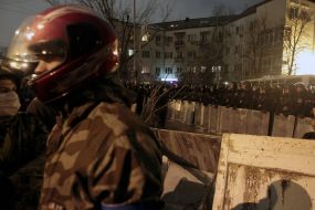 Participants of the mass meeting near the cordon of militia