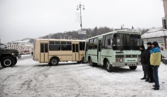 Bus with soldiers of internal troops partitioned off a street