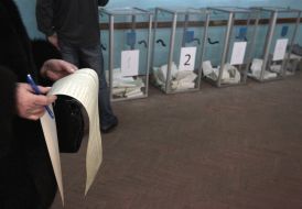 A woman examines a list of candidates