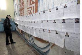 A man examines a list of candidates