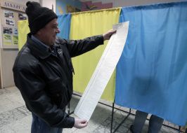 A man examines a list of candidates