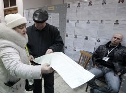 A man examines a list of candidates