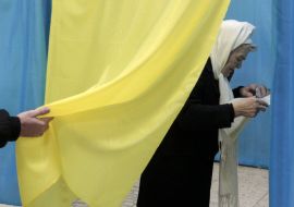 Elderly woman in voting booth