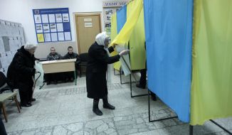 Elderly woman in voting booth