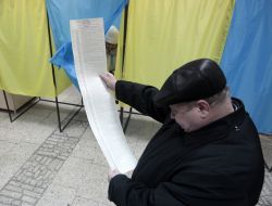 A man examines a list of candidates