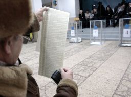 A man examines a list of candidates