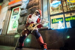 Man in Santa costume playing guitar