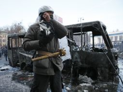 Protesters at the burned bus