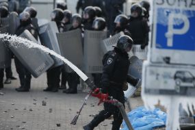 Police officer carries hose