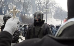 A priest holds a cross