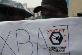 A man holds a placard