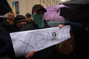 A man holds a placard