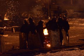 Law enforcers are heated by the fire