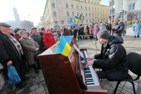 The fellow plays on an piano