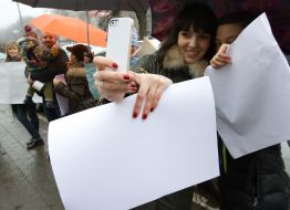 Participants of flash mob in support of the Russian TV channel