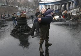 A young man holds a girl on hands 
