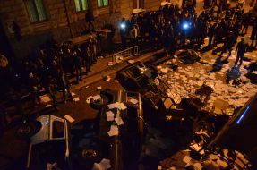 Protesters smash police car