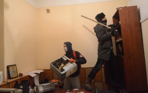 Protesters smash police car