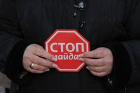 A woman holds a placard "Stop Maidan"