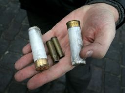 Protesters demonstrate casings from military weapons