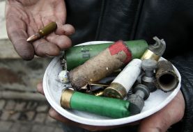 Protesters demonstrate casings from military weapons