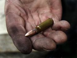 Protesters demonstrate casings from military weapons