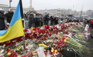 People stand near flowers