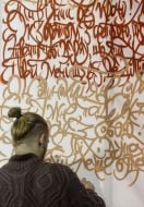 man writes on the wall with a quote of Shevchenko