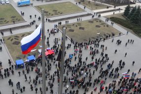 The flag of Russia and mass meeting in Donetsk