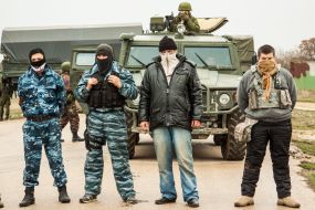 People with guns and hidden faces